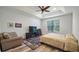 Bedroom with a ceiling fan, TV, and sitting area at 569 Bellflower Way, Clermont, FL 34715