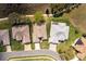 Overhead shot of neighborhood houses, displaying the properties layouts, driveways, and surrounding greenery at 5824 Blue Savannah Dr, Leesburg, FL 34748