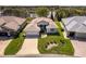 An aerial view of a well maintained home with a manicured lawn and view of the lake at 5824 Blue Savannah Dr, Leesburg, FL 34748