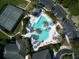 An aerial view showcasing a community pool, parking, and a tennis court at 5824 Blue Savannah Dr, Leesburg, FL 34748