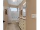 Hall bathroom with a shower-tub combo and a large mirror at 5824 Blue Savannah Dr, Leesburg, FL 34748