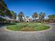 Stunning view of the community clubhouse showcasing the circular driveway, lush landscaping, and impressive architecture at 5824 Blue Savannah Dr, Leesburg, FL 34748