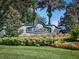 Beautiful Legacy of Leesburg entrance sign featuring lush landscaping, a manicured lawn, and towering palm trees at 5824 Blue Savannah Dr, Leesburg, FL 34748