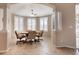 Bright dining room with decorative pillars, neutral colors, tile flooring and shuttered windows at 5824 Blue Savannah Dr, Leesburg, FL 34748