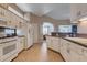 Traditional kitchen with white cabinets, tile flooring, and modern appliances at 5824 Blue Savannah Dr, Leesburg, FL 34748