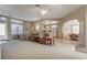 Spacious open-concept living room featuring neutral tones, tile flooring and a view of the kitchen at 5824 Blue Savannah Dr, Leesburg, FL 34748