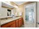 Bathroom featuring a double vanity with granite countertop and a glass-enclosed shower at 592 Netherwood Pl, The Villages, FL 32163