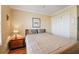 Bedroom with hardwood floors, light beige walls, a ceiling fan, and a closet at 592 Netherwood Pl, The Villages, FL 32163