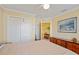 Bedroom with hardwood floors, light beige walls, a ceiling fan, a closet, and lots of furniture at 592 Netherwood Pl, The Villages, FL 32163