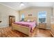 Bright primary bedroom with hard wood floors and soft decor at 592 Netherwood Pl, The Villages, FL 32163