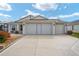 Charming home featuring an attached two-car garage with an extra golf cart garage, a landscaped yard at 592 Netherwood Pl, The Villages, FL 32163