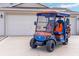 Golf cart parked in front of a clean garage with great outdoor recreational potential at 592 Netherwood Pl, The Villages, FL 32163