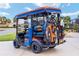 View of a customized golf cart with golf clubs, ideal for enjoying the community's golf course at 592 Netherwood Pl, The Villages, FL 32163