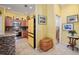 Bright and inviting kitchen showcasing tile floors, wooden cabinetry, and breakfast bar at 592 Netherwood Pl, The Villages, FL 32163