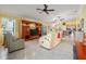 Bright living room featuring tile floors, an entertainment center, and comfortable seating at 592 Netherwood Pl, The Villages, FL 32163