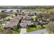 Scenic aerial view of community featuring well-kept homes, mature trees, and lake at 610 Espana St, Lady Lake, FL 32159