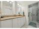 Bright bathroom showcasing a granite vanity, modern fixtures, and glass-enclosed shower at 610 Espana St, Lady Lake, FL 32159