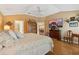 Inviting bedroom featuring hardwood floors, neutral walls and vaulted ceilings at 610 Espana St, The Villages, FL 32159