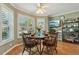 Bright breakfast nook featuring plantation shutters, hardwood floors, and cozy seating at 610 Espana St, The Villages, FL 32159