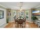 Sunlit breakfast nook featuring wood floors, matching table and chairs and large bay window at 610 Espana St, The Villages, FL 32159