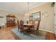 Formal dining area with a wooden table, stylish chairs, and views of the living spaces at 610 Espana St, The Villages, FL 32159