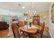 Open-concept dining area featuring a wooden table and chairs, flowing into the living room space at 610 Espana St, The Villages, FL 32159