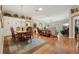 Charming dining room with a wooden table, chandelier, and views into the living area at 610 Espana St, The Villages, FL 32159