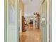 View of the bright foyer showcasing shiny hardwood floors and an open view to the living room beyond at 610 Espana St, The Villages, FL 32159