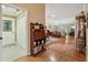 Inviting foyer leading into a bright living space, featuring hardwood floors and ample natural light at 610 Espana St, The Villages, FL 32159