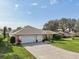 Charming home with a well-manicured lawn, and a spacious three car driveway at 610 Espana St, Lady Lake, FL 32159