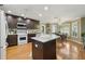 Bright open kitchen featuring a large island, breakfast nook, dark wood cabinets and stainless appliances at 610 Espana St, The Villages, FL 32159