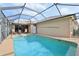 Enjoy the screened in pool and patio with outdoor furniture at 610 Espana St, The Villages, FL 32159