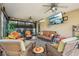 Cozy sunroom with neutral walls, wicker seating, ceiling fans, and ample natural light at 610 Espana St, Lady Lake, FL 32159