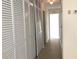 Hallway with neutral walls, carpet and large storage closet at 616 N Hartley Cir, Deltona, FL 32725