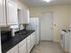 A simple kitchen with white cabinets and appliances and gray countertops at 616 N Hartley Cir, Deltona, FL 32725