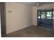 An empty living room with an entrance to a screened in back porch at 616 N Hartley Cir, Deltona, FL 32725