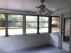 Screened in porch with gray floors and white ceilings at 616 N Hartley Cir, Deltona, FL 32725