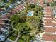 Aerial showcases the community pool, park, and winding sidewalks at 620 Dominguez Dr, The Villages, FL 32159