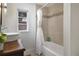 Bright bathroom featuring a standalone sink, a shower-tub combination, and plenty of natural light at 630 E 8Th Ave, Mount Dora, FL 32757