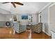 Cozy living room with vaulted ceilings, hardwood floors, two patterned chairs, and great natural light at 630 E 8Th Ave, Mount Dora, FL 32757