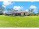 Expansive lawn with fenced-in pool area offering privacy and plenty of space for outdoor activities and relaxation at 6801 Silver Charm Ct, Leesburg, FL 34748