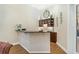 Home bar area with a dark granite countertop, cabinets, and stone backsplash at 6801 Silver Charm Ct, Leesburg, FL 34748