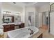 A luxurious bathroom featuring a large soaking tub, dual vanities, and elegant finishes, creating a spa-like atmosphere at 6801 Silver Charm Ct, Leesburg, FL 34748