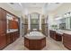 Spacious bathroom with soaking tub, shower, dual vanities, and marble flooring at 6801 Silver Charm Ct, Leesburg, FL 34748