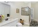 Cozy bathroom featuring a glass door shower and marble countertop vanity at 6801 Silver Charm Ct, Leesburg, FL 34748