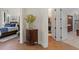 Bedroom entrance showcases a wardrobe and a view of the ensuite bedroom at 6801 Silver Charm Ct, Leesburg, FL 34748