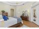 Bedroom featuring a large bed, chandelier lighting, and a double door leading to a balcony at 6801 Silver Charm Ct, Leesburg, FL 34748