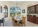 Sun-filled dining room featuring large windows, elegant lighting, and a built-in buffet for entertaining at 6801 Silver Charm Ct, Leesburg, FL 34748