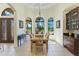 Elegant dining room with arched windows, a chandelier, and a built-in cabinet with granite countertop at 6801 Silver Charm Ct, Leesburg, FL 34748