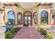 Beautiful arched double front doors framed by side lights at 6801 Silver Charm Ct, Leesburg, FL 34748